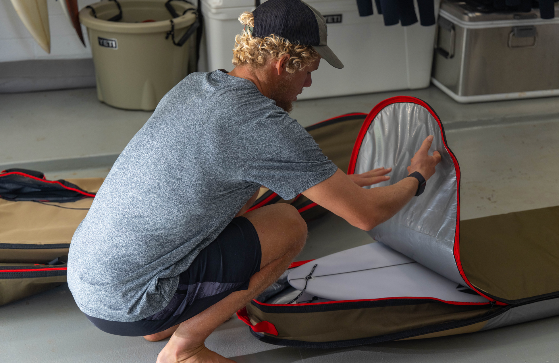 John John Florence putting a board into his VEIA JJF Day Bag