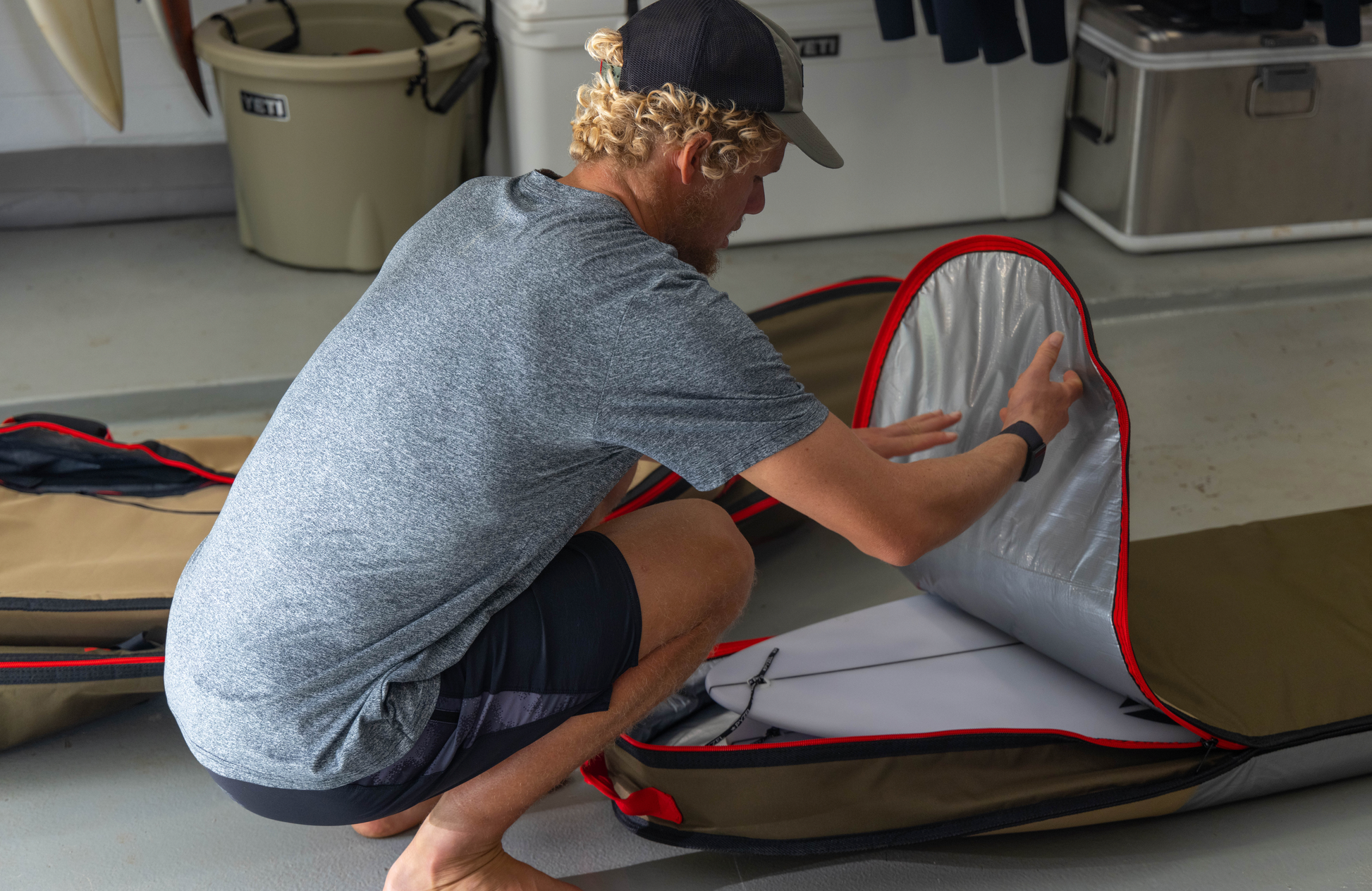 John John Florence putting a board into his VEIA JJF Day Bag 