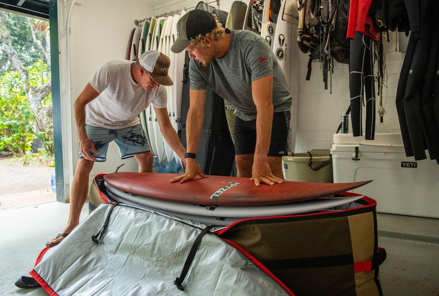 Jon Pyzel and John John Florence packing the VEIA 7 Board Tour Bag